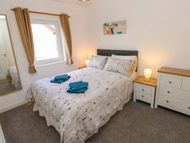A bedroom with bed and bedside table at No.22 The Clicketts in Tenby