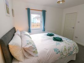 A bedroom with a bed and window at No.22 The Clicketts in Tenby