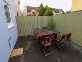 An outdoor seating area with a table and chairs at No.22 The Clicketts Tenby