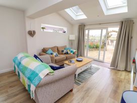 A living room with a sofa and coffee table at Lavender Cottage Beadnell