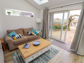 A living room with a sofa and coffee table at Lavender Cottage Beadnell