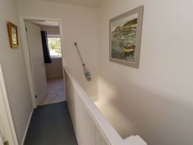 A hallway with a painting on the wall at Lavender Cottage in Beadnell