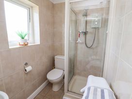 A bathroom with a shower and toilet at Lavender Cottage Beadnell