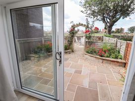 A garden view with flowers and a patio at Lavender Cottage in Beadnell