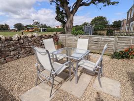 A garden with a table and chairs at Lavender Cottage in Beadnell