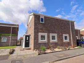 A house with a front door and windows at Lavender Cottage in Beadnell