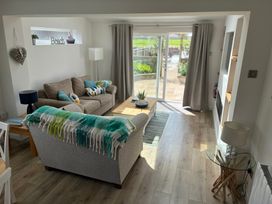 A living room with a sofa and coffee table at Lavender Cottage in Beadnell