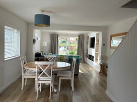 A dining area with a round table and chairs at Lavender Cottage Beadnell
