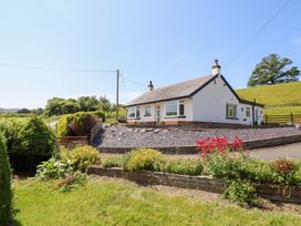 A house with a garden and flowers at Bryn Bras in Corwen