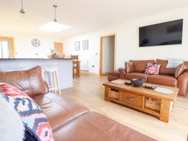 A living room with a sofa and coffee table at Bryn Bras in Corwen