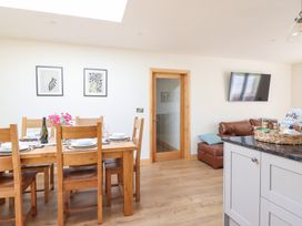 A dining room with a table set for dinner at Bryn Bras in Corwen