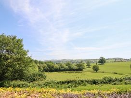 A scenic view of trees and hills at Bryn Bras in Corwen