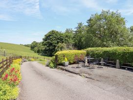 An outdoor sitting area with a table and chairs at Bryn Bras in Corwen