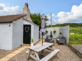 An outdoor area with a table and chairs at High Wreah Bolt Hole in Cleator Moor