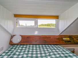 A bedroom with a window and bedding at High Wreah Bolt Hole in Cleator Moor