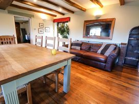 A dining room with a table and chairs at Home Farm St Asaph