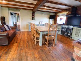 A kitchen with a dining table and chairs at Home Farm in St Asaph