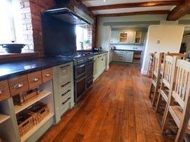 A kitchen with cabinets and an oven at Home Farm St Asaph