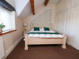 A bedroom with a bed and nightstand at Home Farm in St Asaph