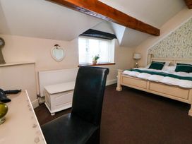 A bedroom with a bed and desk at Home Farm St Asaph