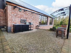 An outdoor space with a barbecue grill and counter at Home Farm St Asaph