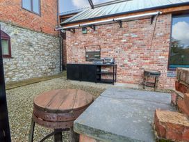 An outdoor area with a grill and seating at Home Farm St Asaph