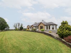 A house with a lawn and trees at Swan Lake in Cloonshaghan near Boyle, County Roscommon