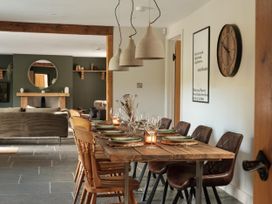 A dining room with a table set for meals at Lower Well Farm House in Totnes