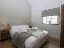 A bedroom with a bed and nightstand at Beudy