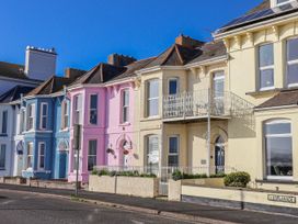 A row of colorful houses with a balcony at Sea Lovers in Exmouth