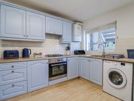 A kitchen with blue cabinets and appliances at Sea Lovers in Exmouth