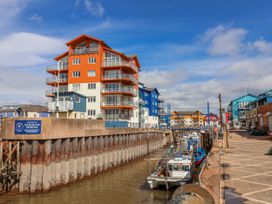 A marina with boats and colorful buildings at Sea Lovers in Exmouth