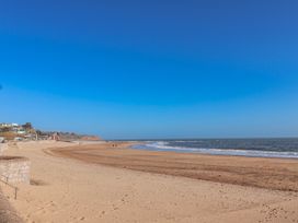 A beach scene with sand and water at Sea Lovers in Exmouth