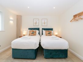 A bedroom with two beds and wall art at Hidden Well in Aust