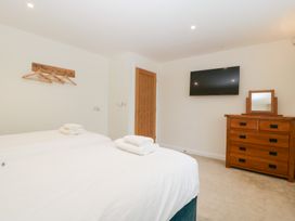 A bedroom with two beds and a television at Hidden Well in Aust