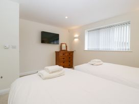 A bedroom with two beds and a television at Hidden Well in Aust