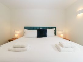 A bedroom with a bed and bedside lamps at Hidden Well in Aust