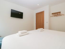 A bedroom with a bed and television at Hidden Well in Aust