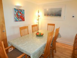A dining room with a table and chairs at 5 Thurlestone Beach in Thurlestone