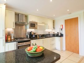 A kitchen with appliances and a fruit bowl at 5 Thurlestone Beach in Thurlestone