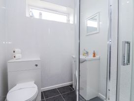 A bathroom with a toilet and sink at Shells Cottage in Looe