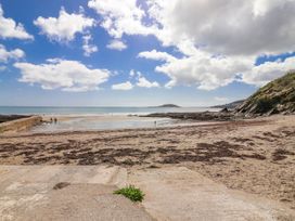 A beach with clouds and sea at Shells Cottage in Looe