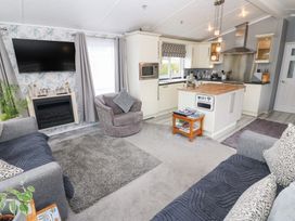 A living room with a sofa and armchair at A and C Lodge-Plot 21 Armathwaite