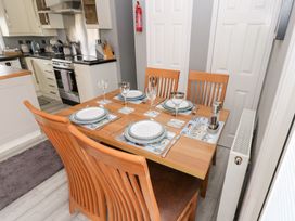 A dining area with a table set for four at A and C Lodge-Plot 21 Armathwaite