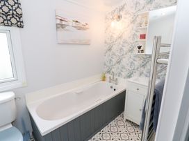 A bathroom with a bath tub and sink at A and C Lodge-Plot 21 Armathwaite