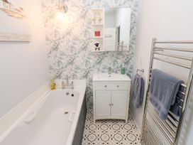 A bathroom with a bathtub and sink at A and C Lodge-Plot 21 Armathwaite