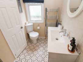 A bathroom with a toilet and sink at A and C Lodge-Plot 21 Armathwaite