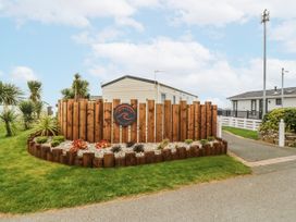 A sign in front of a fenced garden at Seaviews in Nefyn