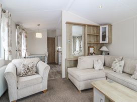 A living room with a sofa and armchair at Seaviews Nefyn