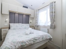A bedroom with a bed and bedside table at Seaviews in Nefyn